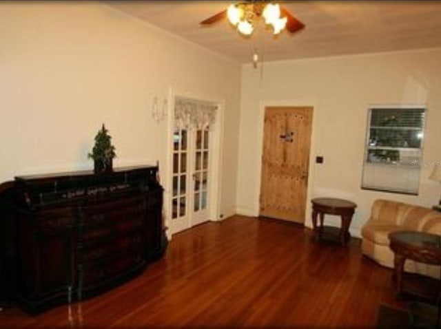 living area with ceiling fan and dark hardwood / wood-style flooring