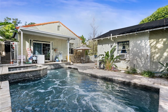 view of pool featuring a patio area and an in ground hot tub