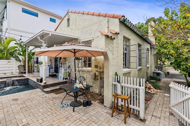 rear view of property featuring a patio area