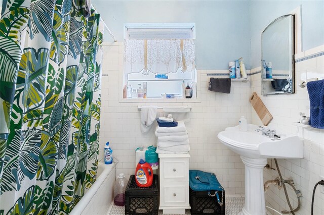 bathroom with tile walls, tile patterned flooring, and shower / bathtub combination with curtain