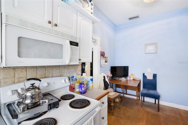 kitchen featuring white appliances, white cabinetry, and dark hardwood / wood-style floors