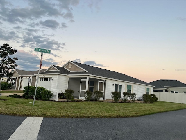 ranch-style house featuring a lawn and a garage