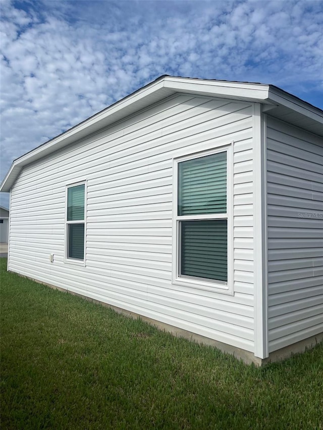 view of side of property featuring a yard