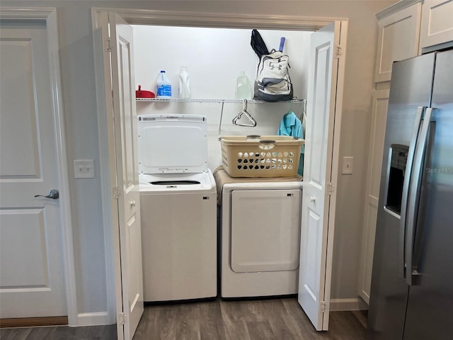 washroom featuring dark hardwood / wood-style flooring and washing machine and clothes dryer