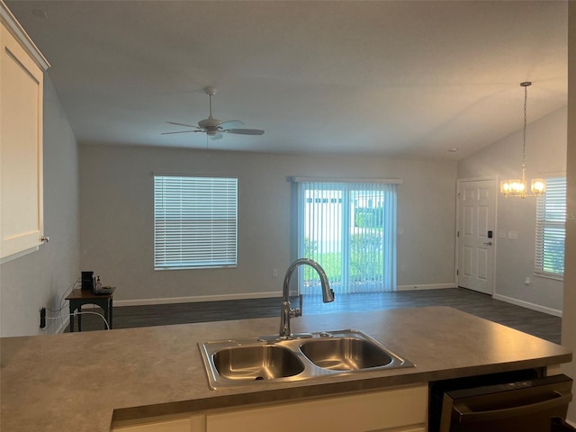 kitchen featuring white cabinets, plenty of natural light, lofted ceiling, and sink