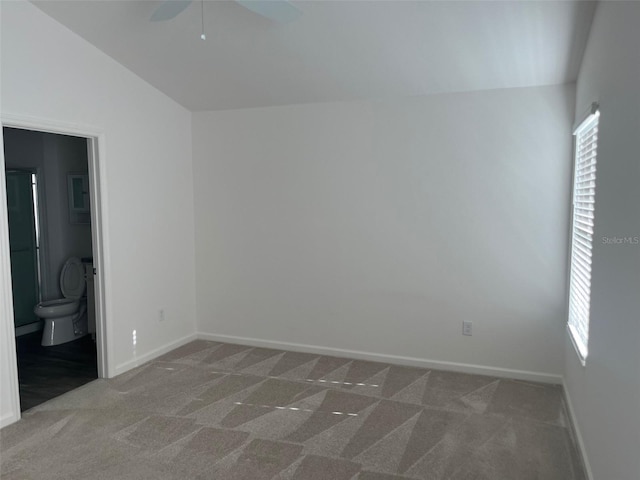 unfurnished room with ceiling fan, carpet, and vaulted ceiling