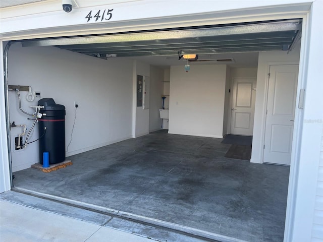 garage featuring electric panel and a garage door opener