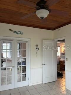 interior space featuring light tile patterned flooring, wood ceiling, and french doors