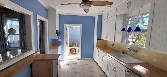 kitchen with tasteful backsplash, ceiling fan, sink, white cabinets, and light tile patterned flooring