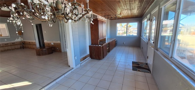 interior space featuring wood ceiling and an inviting chandelier