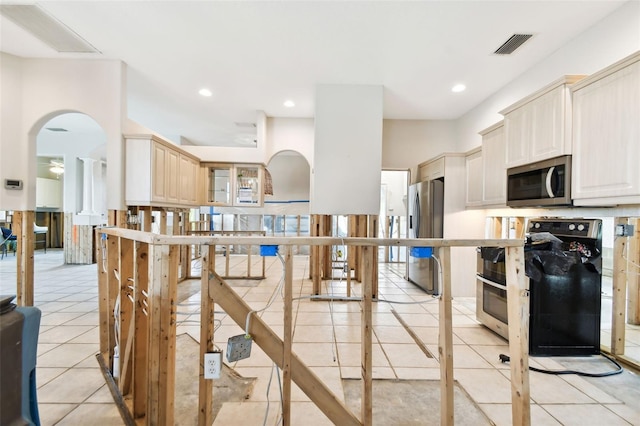 kitchen featuring stainless steel appliances and light tile patterned floors