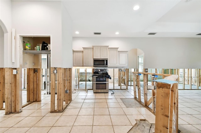 kitchen featuring light tile patterned flooring and stainless steel appliances