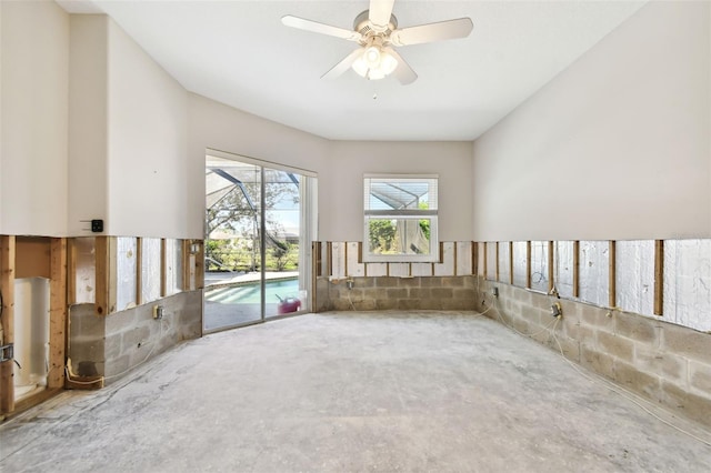 spare room with ceiling fan and concrete floors