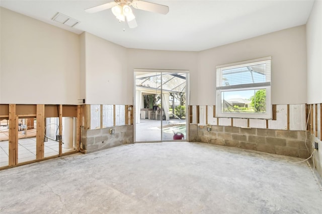 spare room featuring concrete flooring and ceiling fan