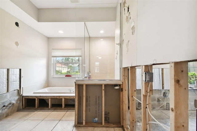 bathroom with tile patterned floors and a bathing tub