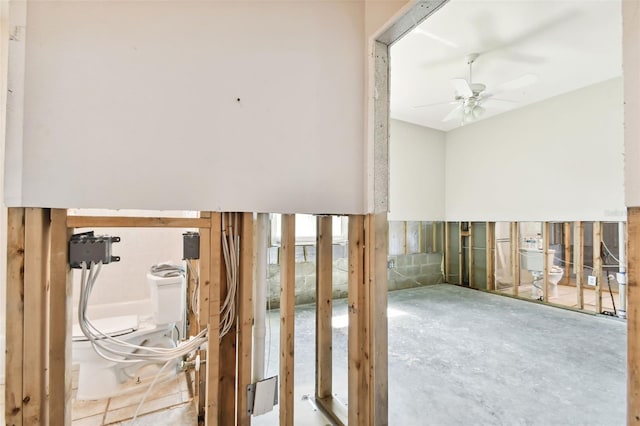 stairs featuring ceiling fan and concrete flooring