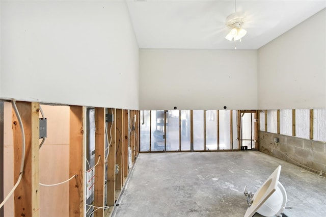 empty room with concrete flooring and ceiling fan