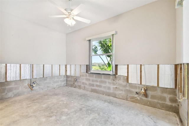 spare room with ceiling fan and concrete flooring