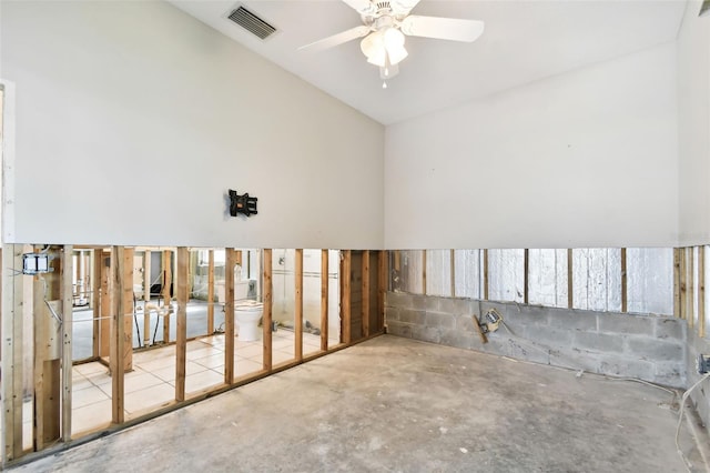 unfurnished room with ceiling fan and concrete floors