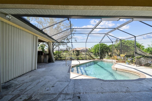 view of pool with a lanai and a patio