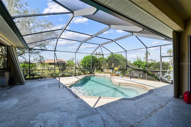 view of pool with a patio and a lanai