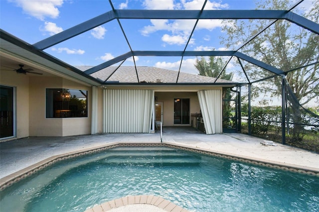 view of swimming pool featuring ceiling fan, a patio, and a lanai