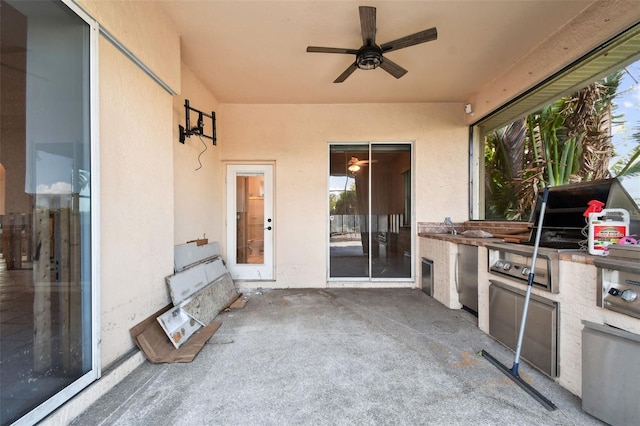 view of patio with ceiling fan and an outdoor kitchen