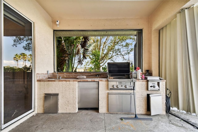 view of patio featuring grilling area, an outdoor kitchen, and sink