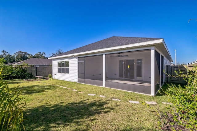 back of property with a patio, a yard, and ceiling fan