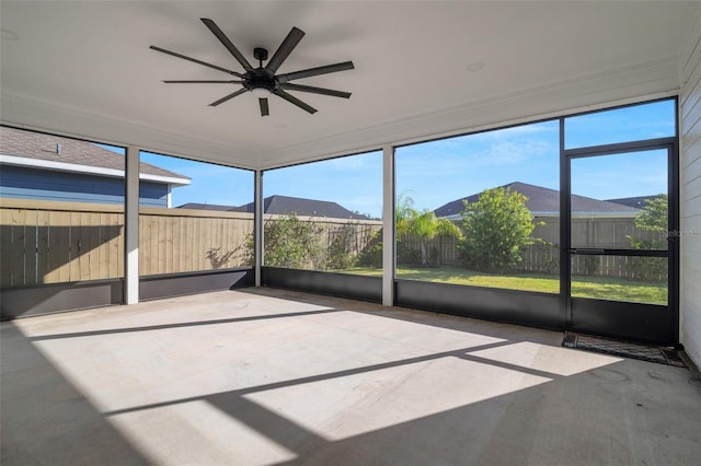 unfurnished sunroom with ceiling fan and a wealth of natural light