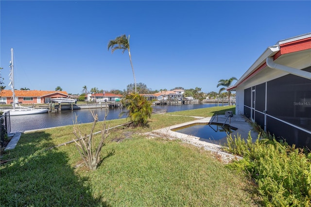 view of yard featuring a boat dock and a water view