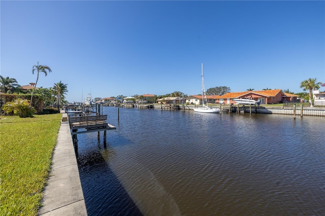 view of dock featuring a yard and a water view