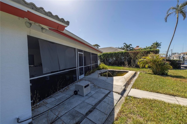 view of patio / terrace featuring a sunroom