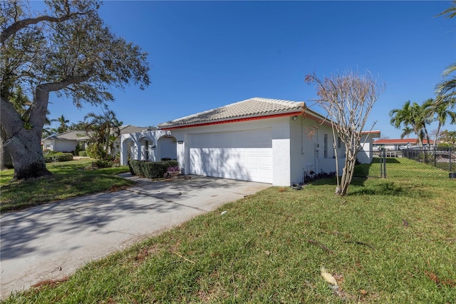 view of side of property featuring a yard and a garage