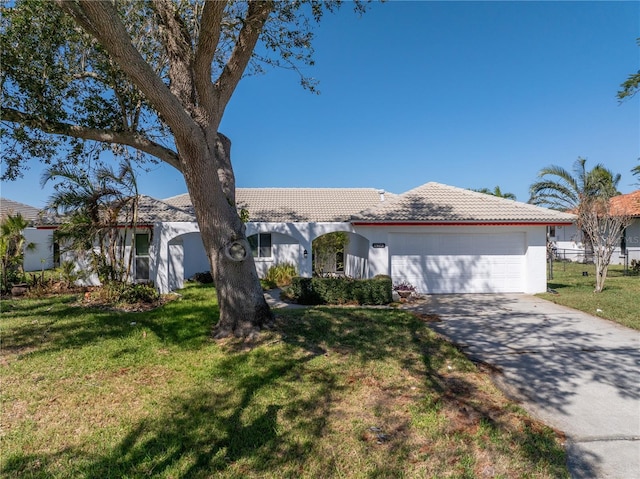 view of front of house featuring a garage and a front lawn