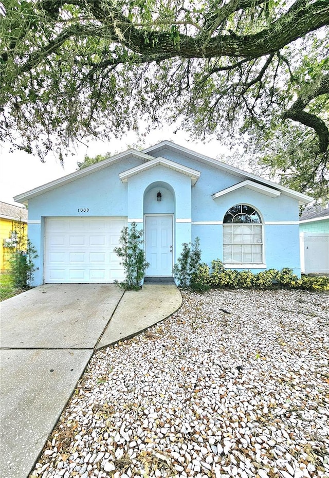 ranch-style home featuring a garage