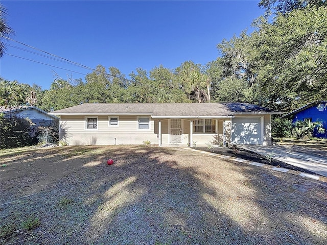 ranch-style home with a porch and a garage