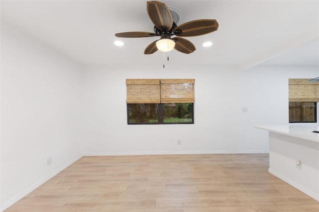 empty room featuring ceiling fan and light wood-type flooring