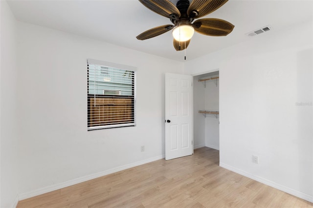 unfurnished bedroom featuring ceiling fan, a closet, and light hardwood / wood-style floors