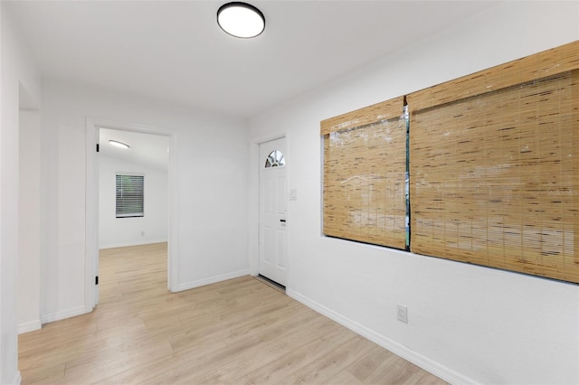 corridor with light hardwood / wood-style floors