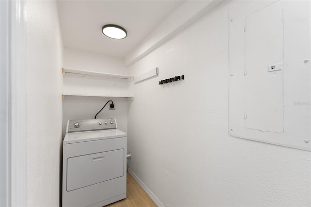 laundry room featuring light hardwood / wood-style flooring, washer / dryer, and electric panel