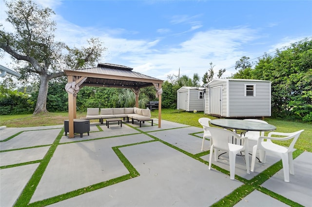 view of patio / terrace featuring a gazebo, an outdoor living space, and a storage shed