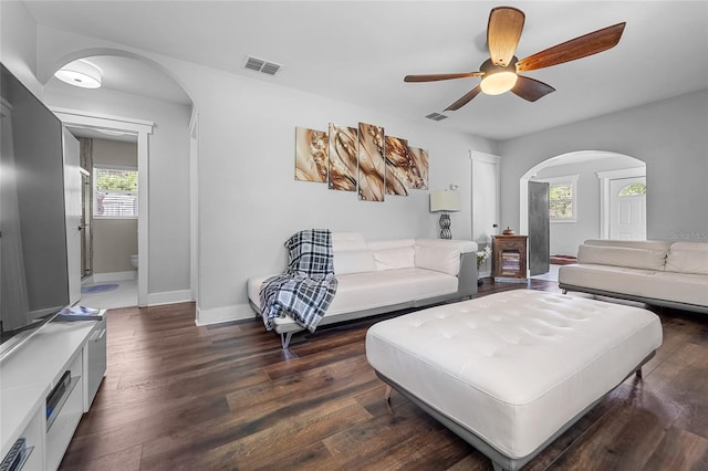 living room with ceiling fan and dark hardwood / wood-style floors