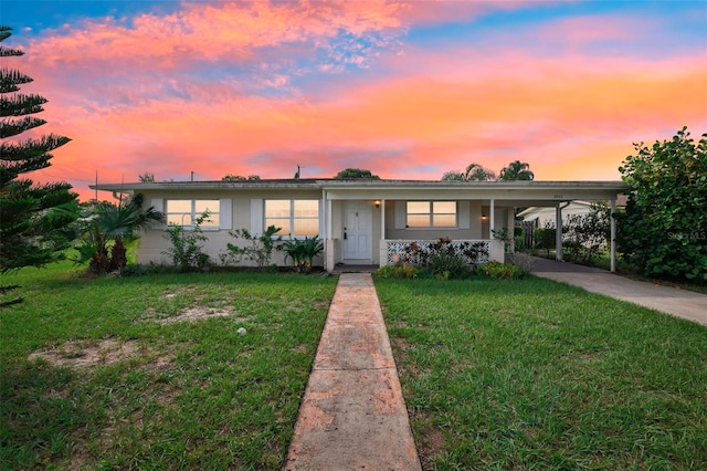 single story home with a yard and a carport