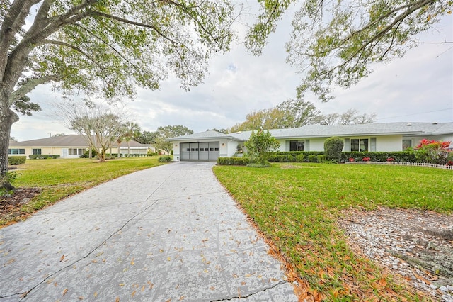 single story home with a front yard and a garage