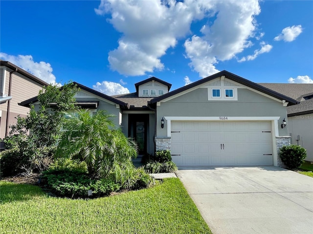 view of front of home with a front yard and a garage