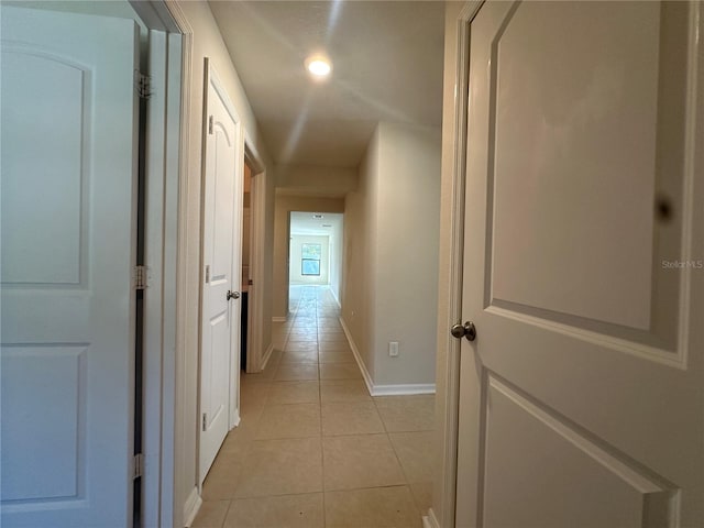 hall featuring light tile patterned flooring