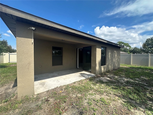 rear view of house featuring a patio