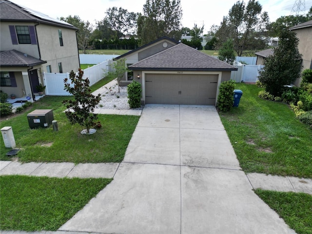 view of front of home featuring a front yard and a garage