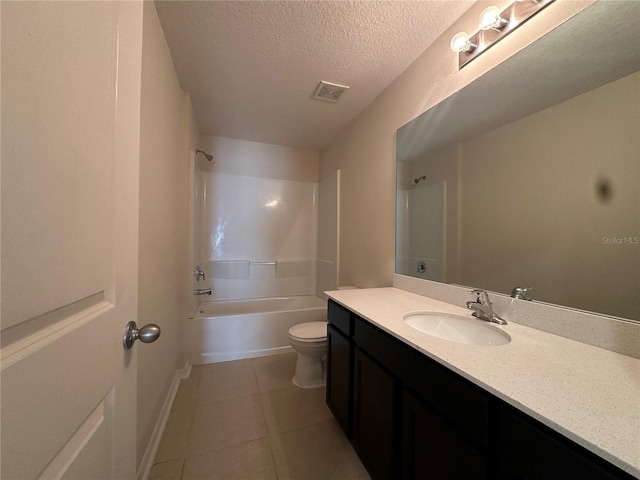 full bathroom featuring washtub / shower combination, tile patterned floors, a textured ceiling, toilet, and vanity